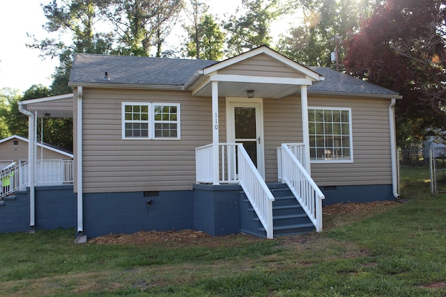 bungalow-style home featuring crawl space, a shingled roof, and a front lawn