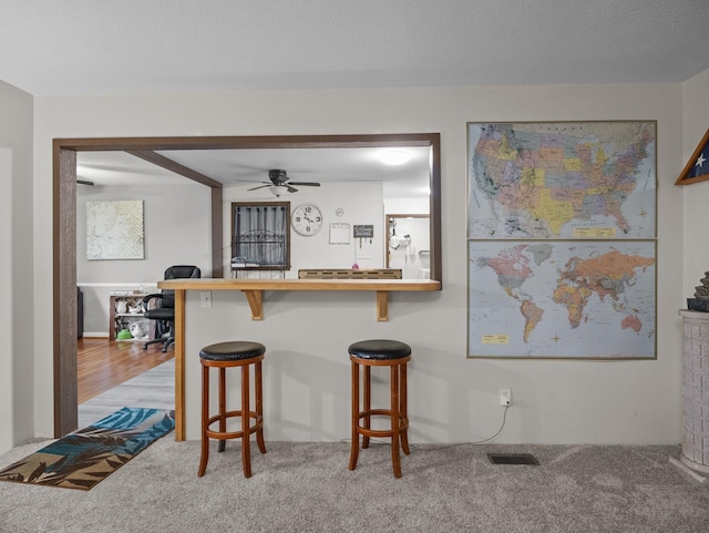 228 Anita, Spartanburg, SC 29302 - kitchen featuring ceiling fan, a kitchen breakfast bar, visible vents, and carpet