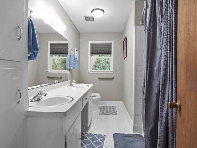 228 Anita, Spartanburg, SC 29302 - bathroom with tile patterned flooring, a sink, double vanity, and toilet