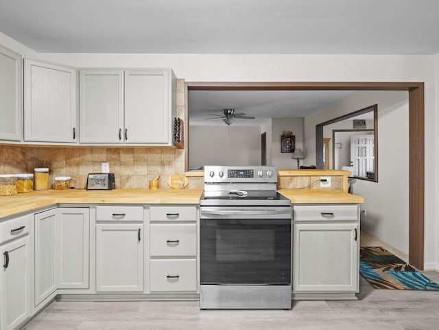 228 Anita, Spartanburg, SC 29302 - kitchen with a ceiling fan, light wood-style floors, decorative backsplash, stainless steel electric range, and butcher block countertops