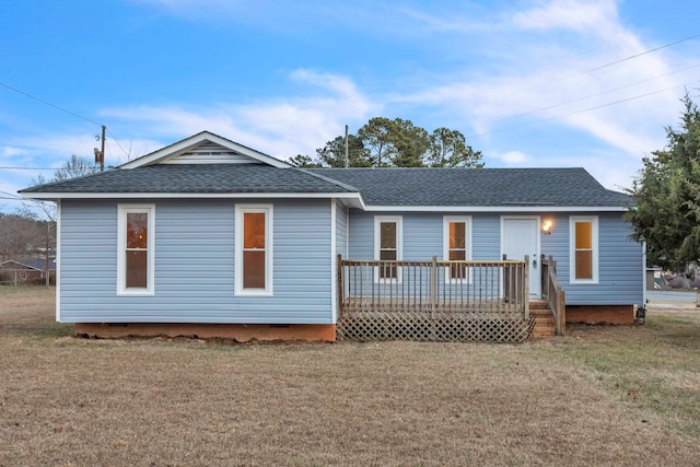 view of front facade featuring a deck, crawl space, a front yard, and a shingled roof