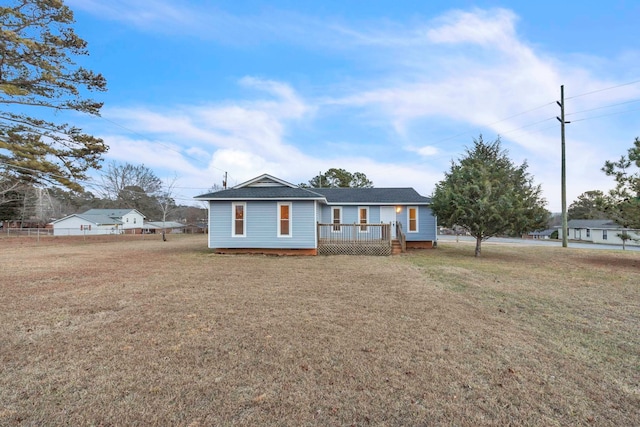 view of front of property featuring a wooden deck and a front yard