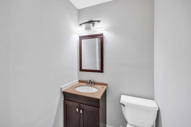 bathroom with toilet and vanity