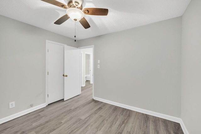 unfurnished bedroom featuring baseboards, a ceiling fan, and wood finished floors