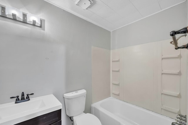 bathroom featuring washtub / shower combination, toilet, and vanity