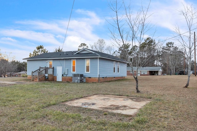 view of side of property with a shingled roof, crawl space, a lawn, and cooling unit