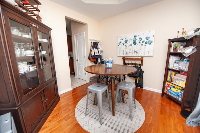 dining room featuring baseboards and light wood-type flooring