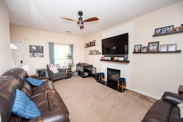 living room with a ceiling fan, a fireplace with flush hearth, baseboards, carpet flooring, and visible vents