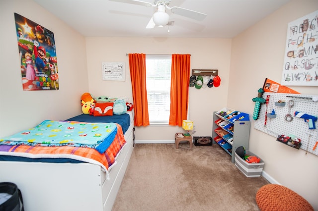 carpeted bedroom with ceiling fan and baseboards