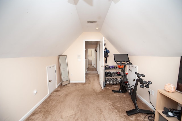 exercise room featuring vaulted ceiling, ceiling fan, carpet, baseboards, and visible vents