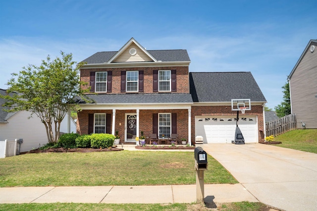 traditional home with fence, an attached garage, brick siding, and concrete driveway
