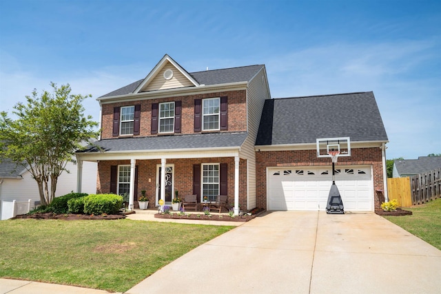 traditional-style home featuring concrete driveway, fence, a porch, a front yard, and brick siding