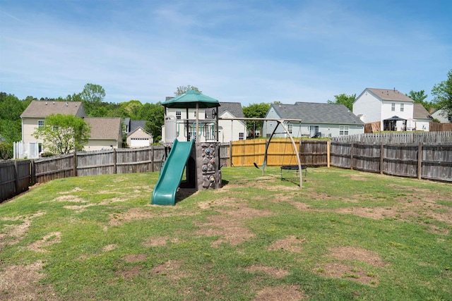 view of play area with a residential view, a lawn, and a fenced backyard