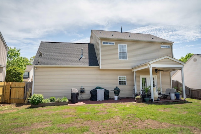 back of property featuring a gate, fence, a ceiling fan, a lawn, and a patio