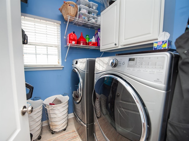 laundry room with washing machine and dryer and cabinet space