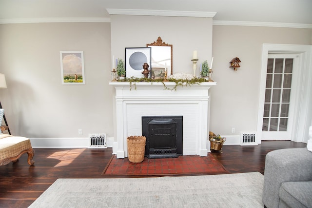 living area with a fireplace with flush hearth, wood finished floors, visible vents, and ornamental molding