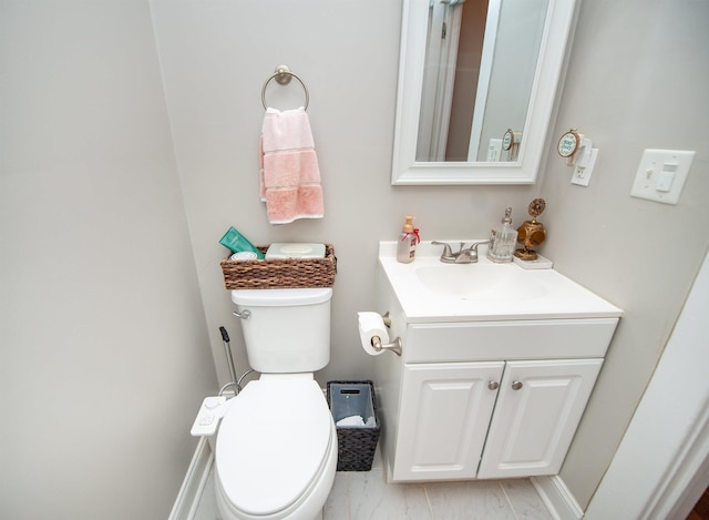 half bathroom featuring toilet and vanity