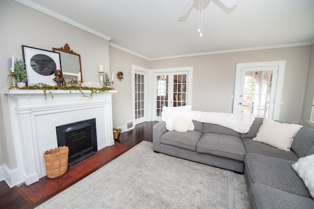 living room with ceiling fan, crown molding, visible vents, and a healthy amount of sunlight