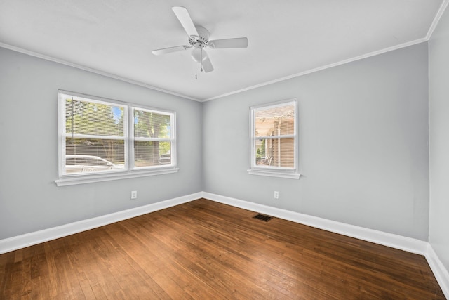 unfurnished room featuring baseboards, visible vents, a healthy amount of sunlight, and crown molding