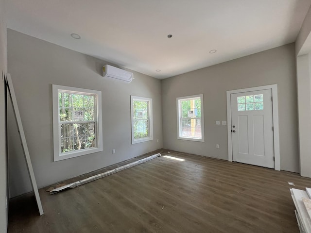 entryway featuring an AC wall unit and wood finished floors