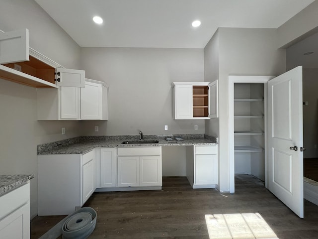 kitchen featuring recessed lighting, dark wood-style floors, open shelves, a sink, and white cabinetry