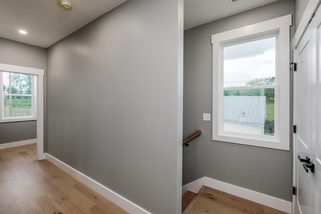 entryway with light wood finished floors and baseboards