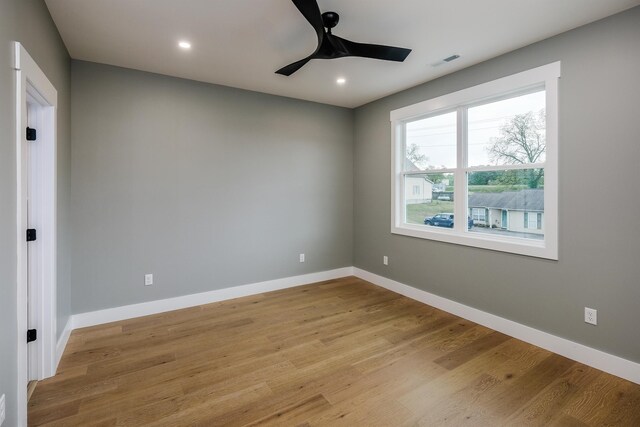 empty room with a ceiling fan, light wood-style flooring, baseboards, visible vents, and recessed lighting