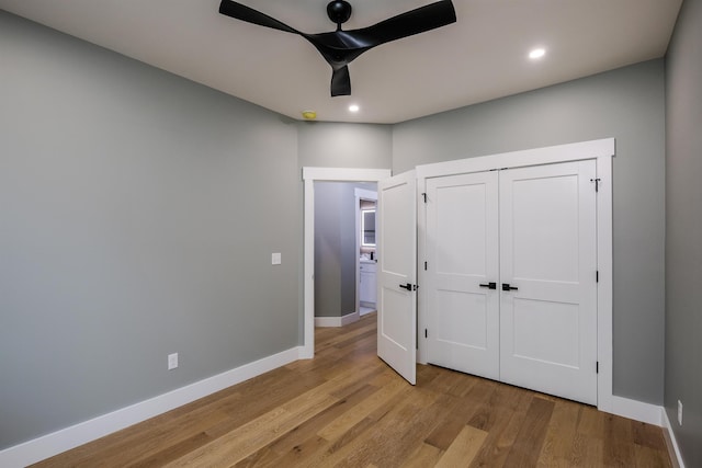 unfurnished bedroom with baseboards, wood finished floors, and recessed lighting