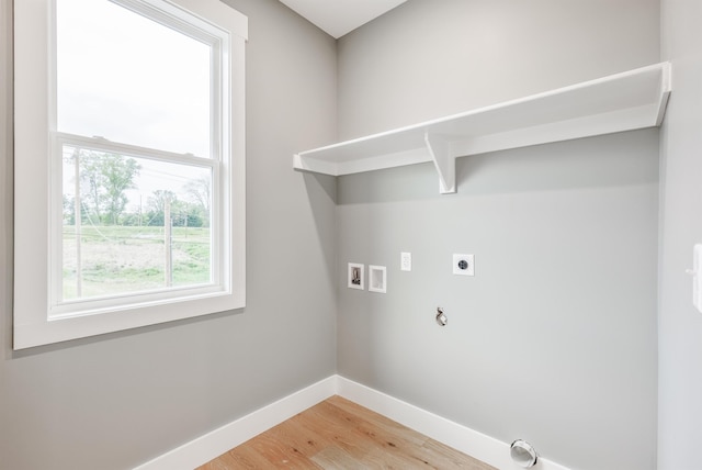 laundry room with light wood finished floors, hookup for an electric dryer, baseboards, washer hookup, and laundry area