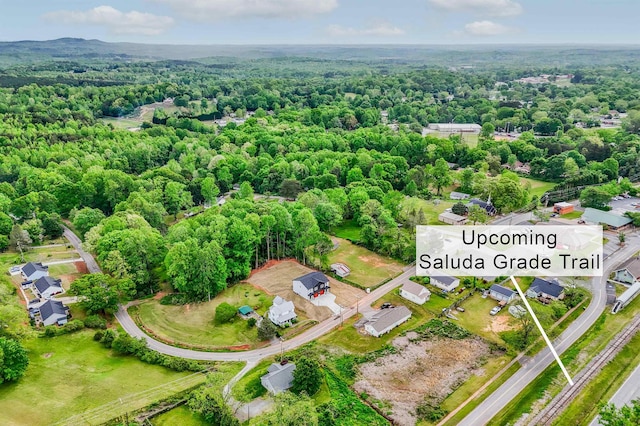 drone / aerial view featuring a forest view