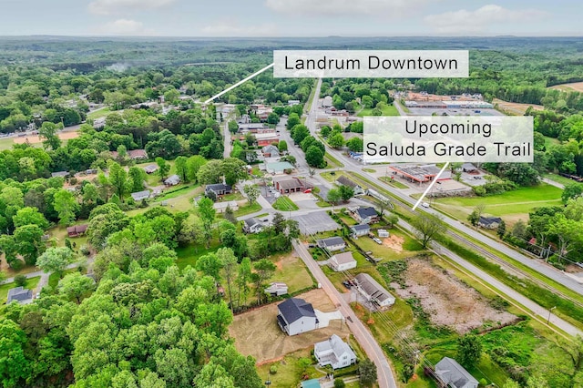 birds eye view of property with a wooded view