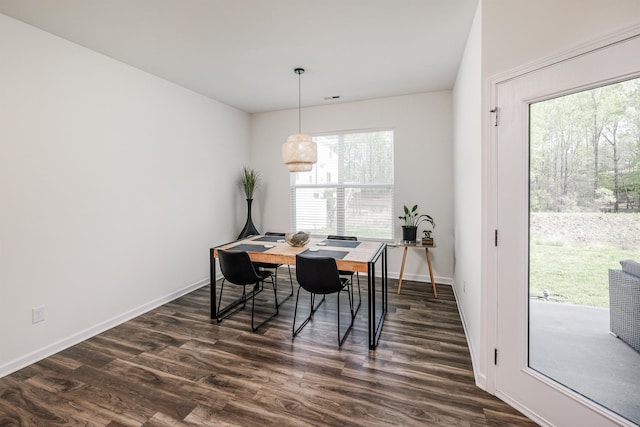 dining area with baseboards, visible vents, and dark wood-type flooring