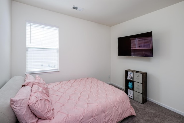 bedroom featuring baseboards, visible vents, and carpet