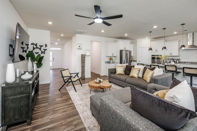 living room with visible vents, baseboards, dark wood-style flooring, recessed lighting, and a ceiling fan