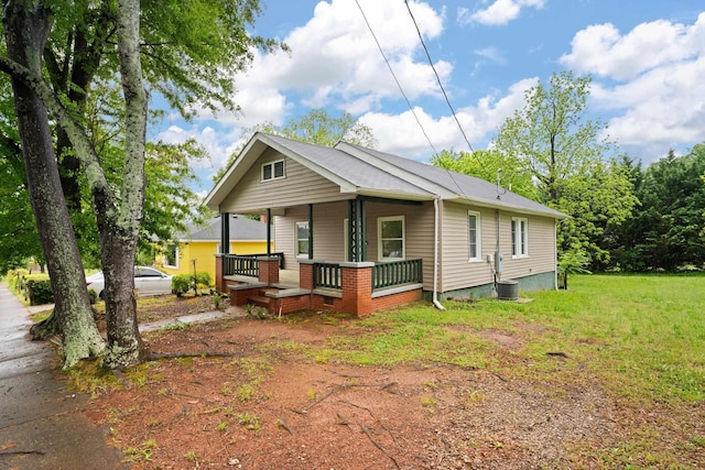 view of front facade with central AC, a porch, and a front lawn
