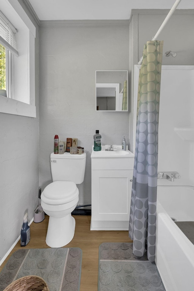 full bath featuring toilet, vanity, shower / tub combo, and wood finished floors