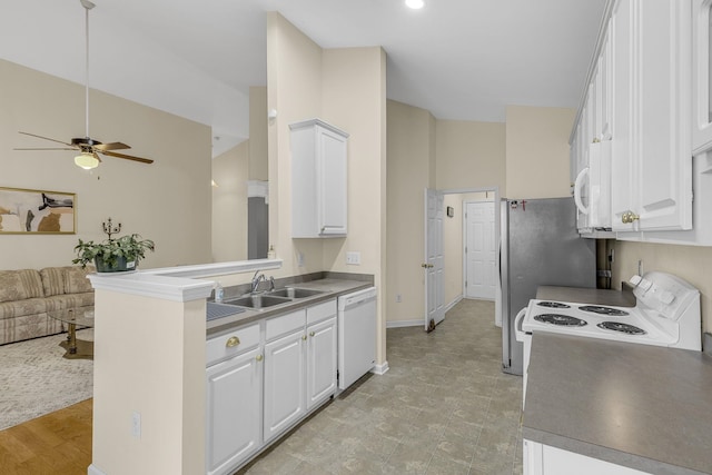 kitchen featuring white cabinets, a sink, ceiling fan, open floor plan, and white appliances