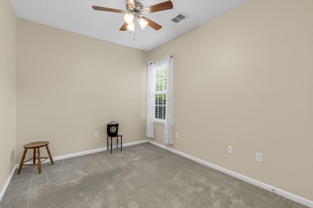 carpeted empty room featuring a ceiling fan, visible vents, and baseboards