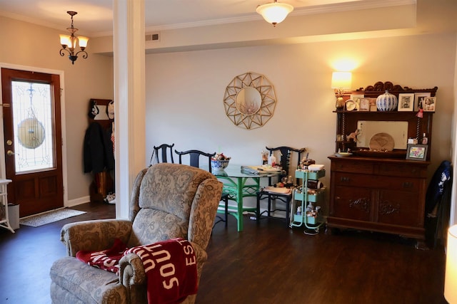 entrance foyer with wood finished floors, a chandelier, baseboards, visible vents, and crown molding
