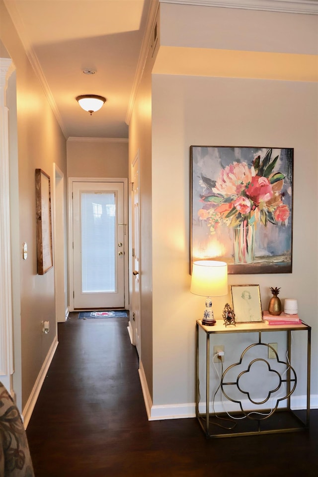 hallway featuring dark wood-style flooring, crown molding, and baseboards