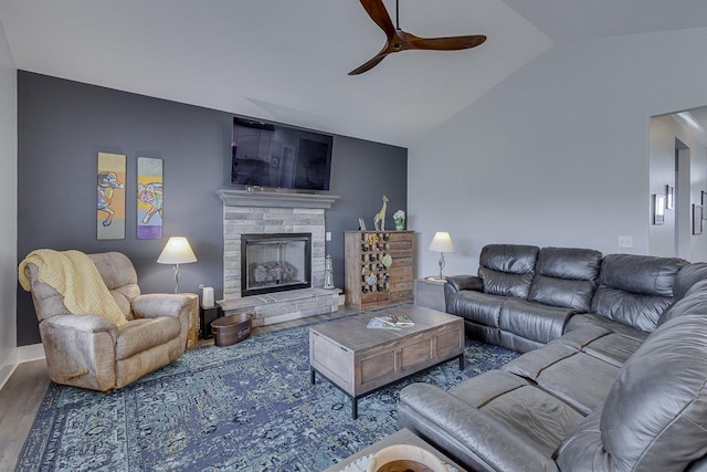 living room with a ceiling fan, a stone fireplace, high vaulted ceiling, and wood finished floors