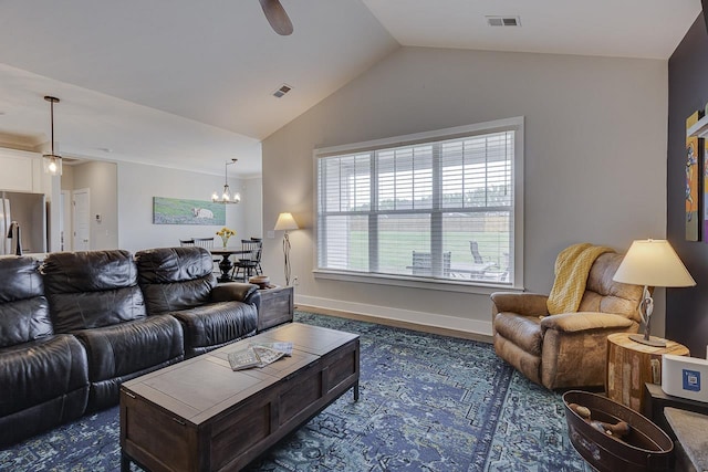 living room featuring baseboards, visible vents, ceiling fan with notable chandelier, and vaulted ceiling
