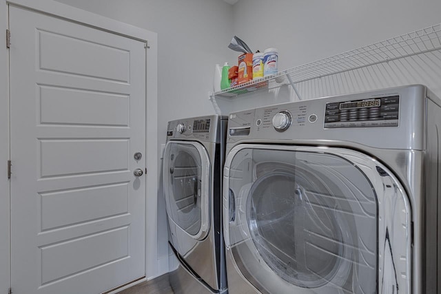 washroom featuring laundry area and washing machine and dryer