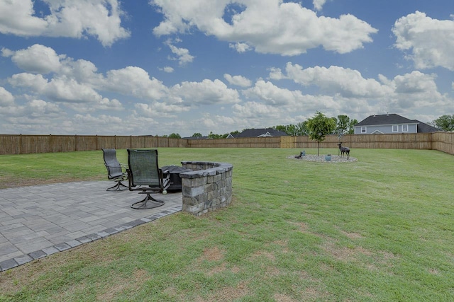 view of yard with a patio area, an outdoor fire pit, and a fenced backyard