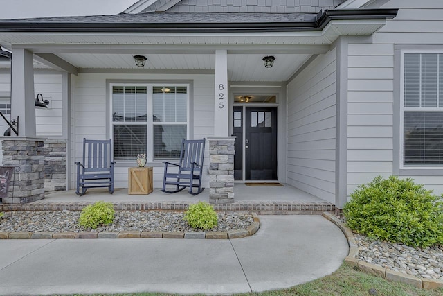 view of exterior entry with covered porch