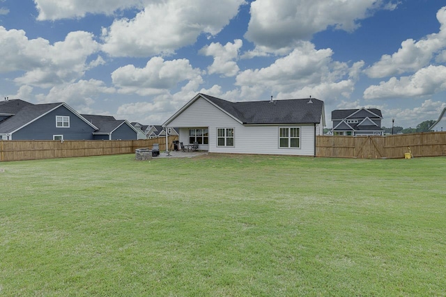 rear view of property featuring a patio, a fenced backyard, and a lawn
