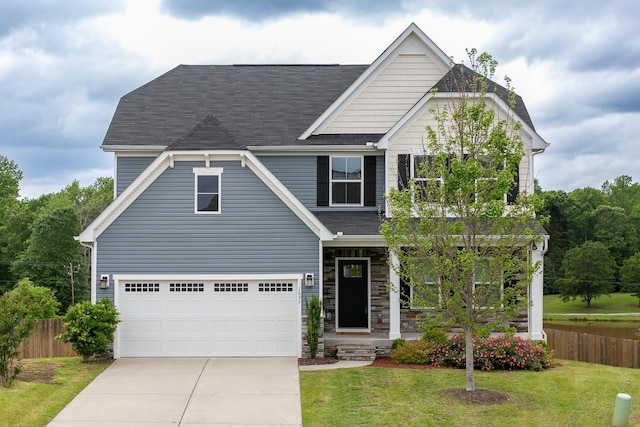 craftsman-style house featuring fence, concrete driveway, a front yard, and an attached garage