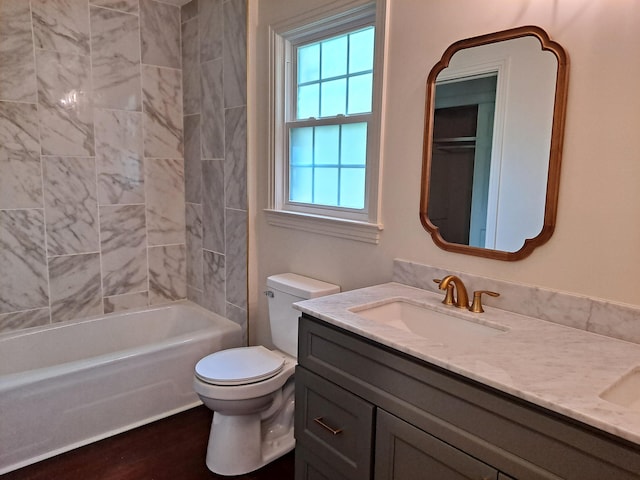 full bathroom with wood finished floors, vanity, toilet, and  shower combination