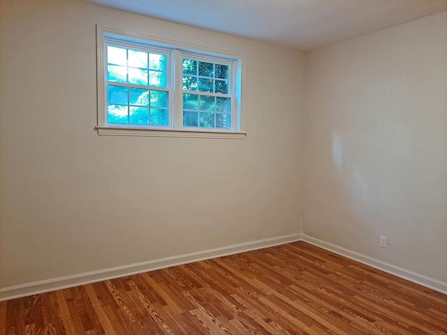 empty room with baseboards and light wood finished floors