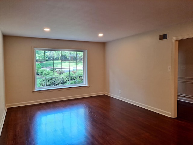 unfurnished room featuring dark wood-style floors, visible vents, recessed lighting, and baseboards